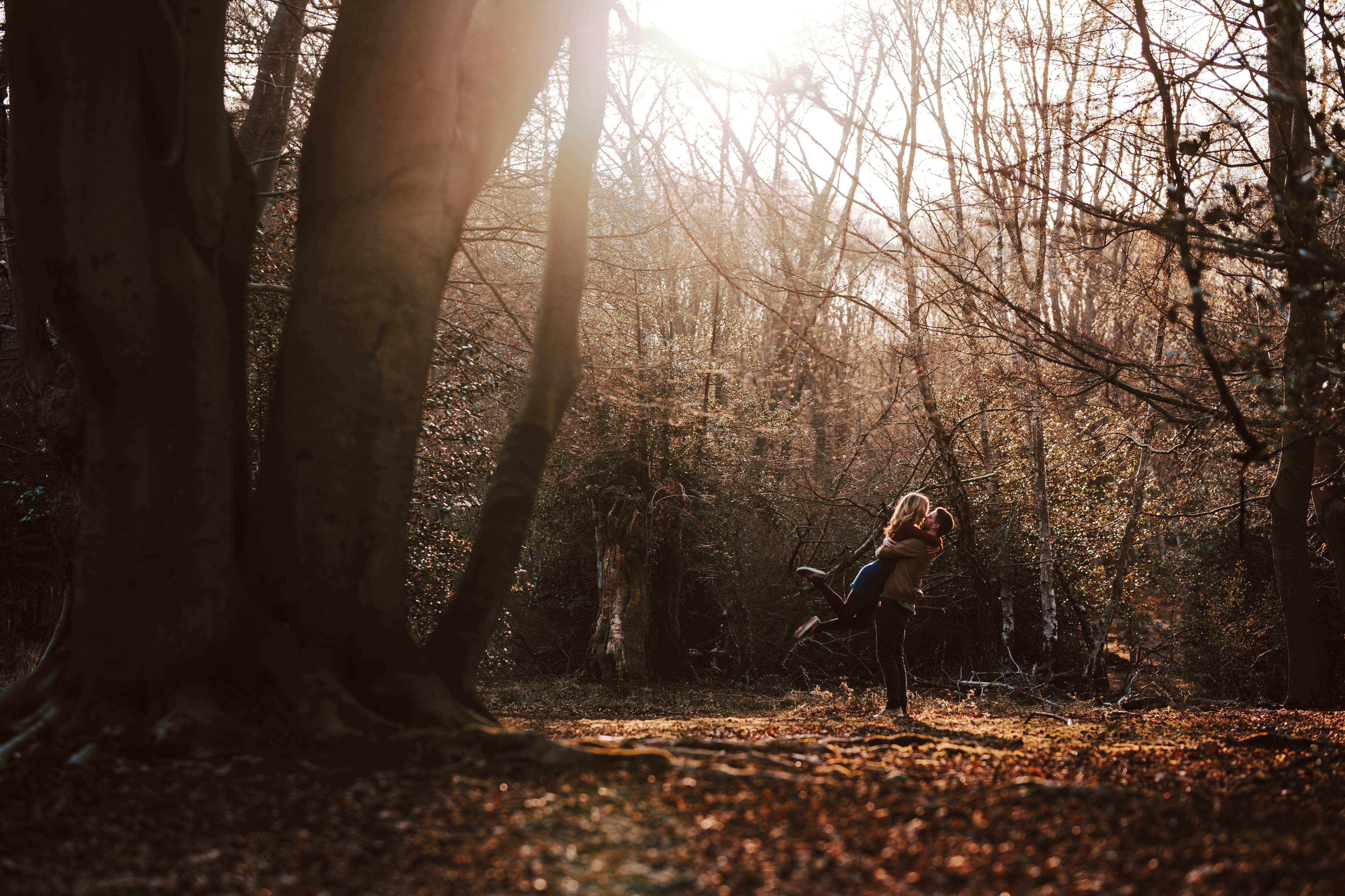 romantic boho engagement photoshoot of couple in the woods