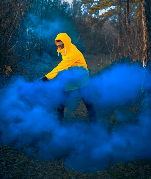 Man Wearing Hoodie Near Blue Smoke