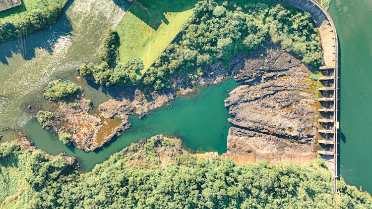 Aerial View Of A Landscape With A Dam 