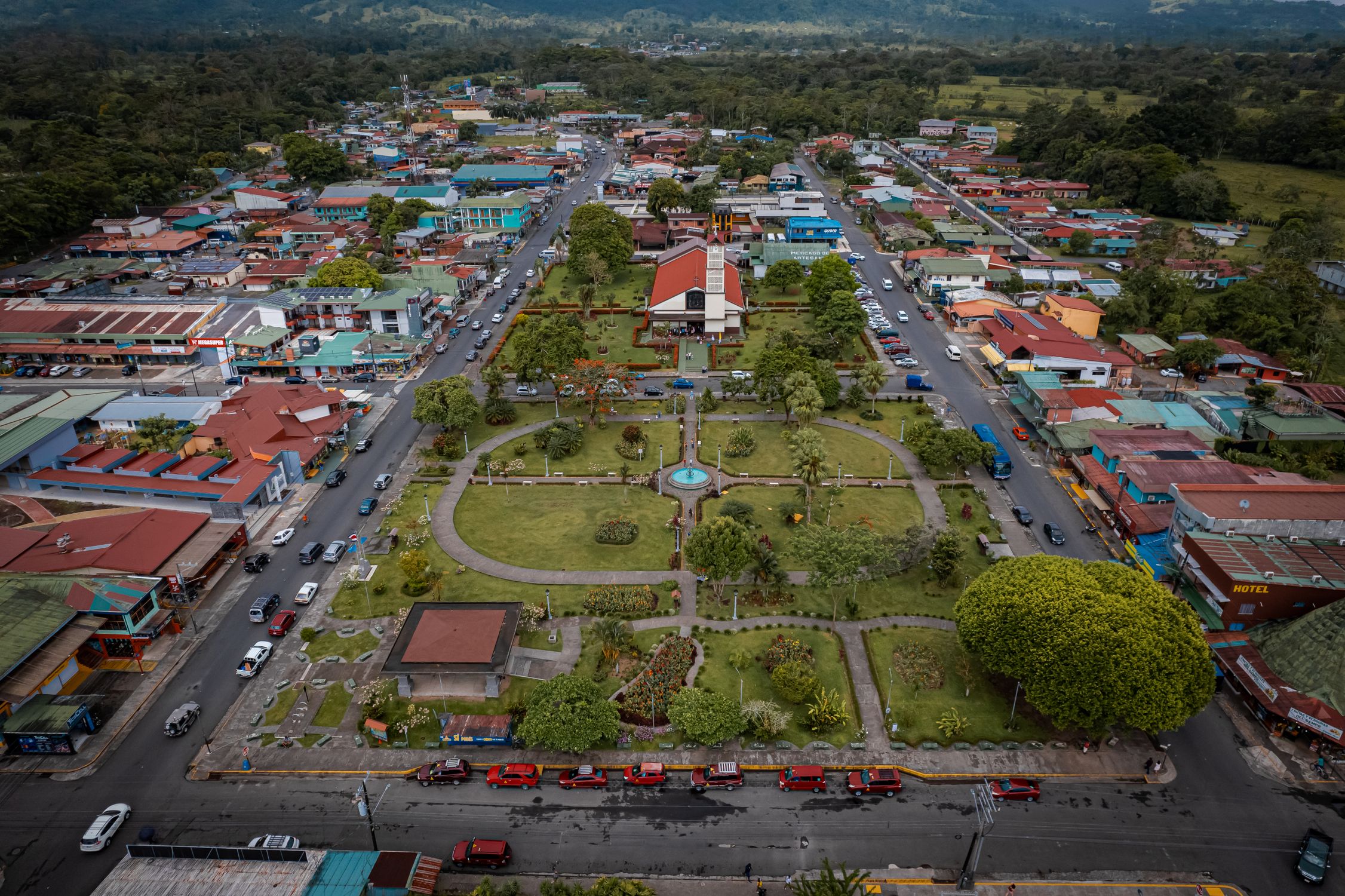 Bird's eye view of La Fortuna town in Costa Rica, capturing urban life and greenery.