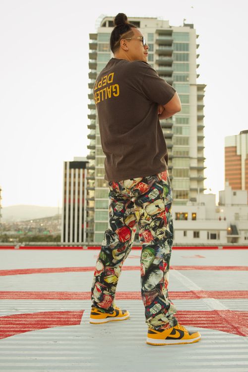 Free Stylish man poses on a rooftop in Los Angeles, showcasing urban fashion with a vibrant cityscape backdrop. Stock Photo