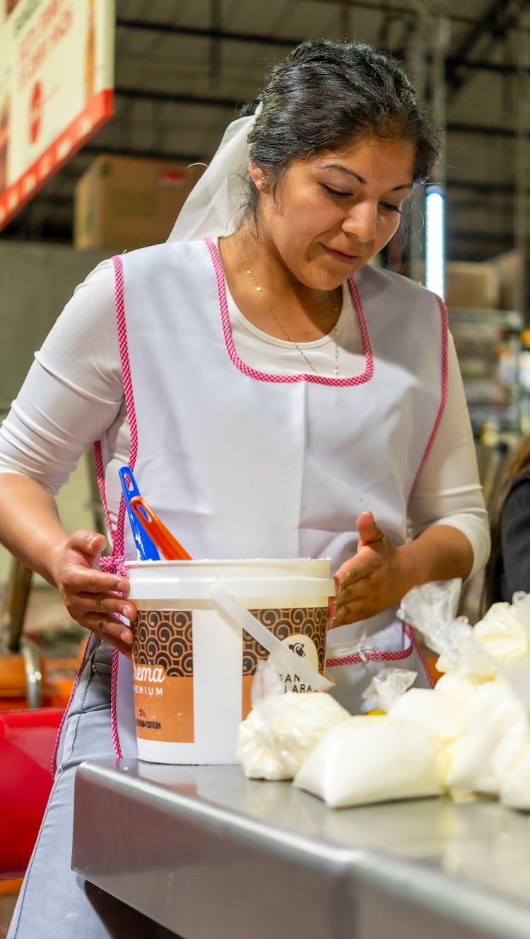 Woman In Apron Working In Kitchen