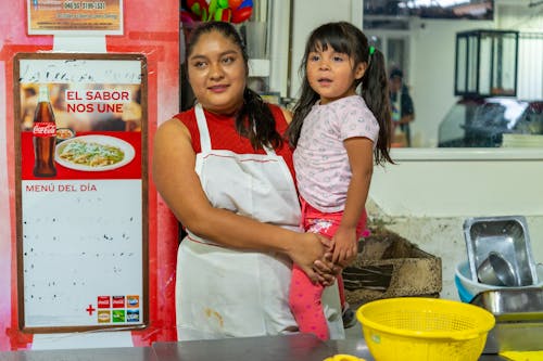 Free Mother Standing and Holding Daughter Stock Photo