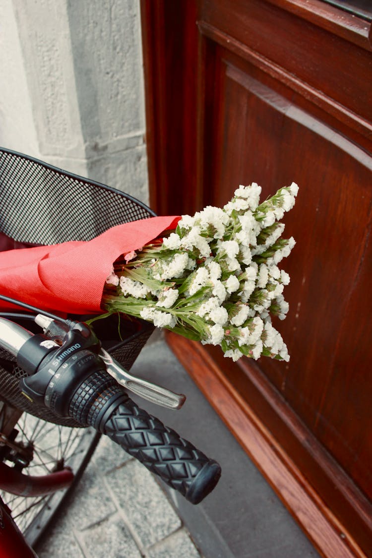 A Bunch Of Flowers In A Bicycle Basket 