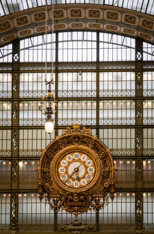 Free Golden ornate clock inside Musée d'Orsay Paris captures artistic elegance. Stock Photo