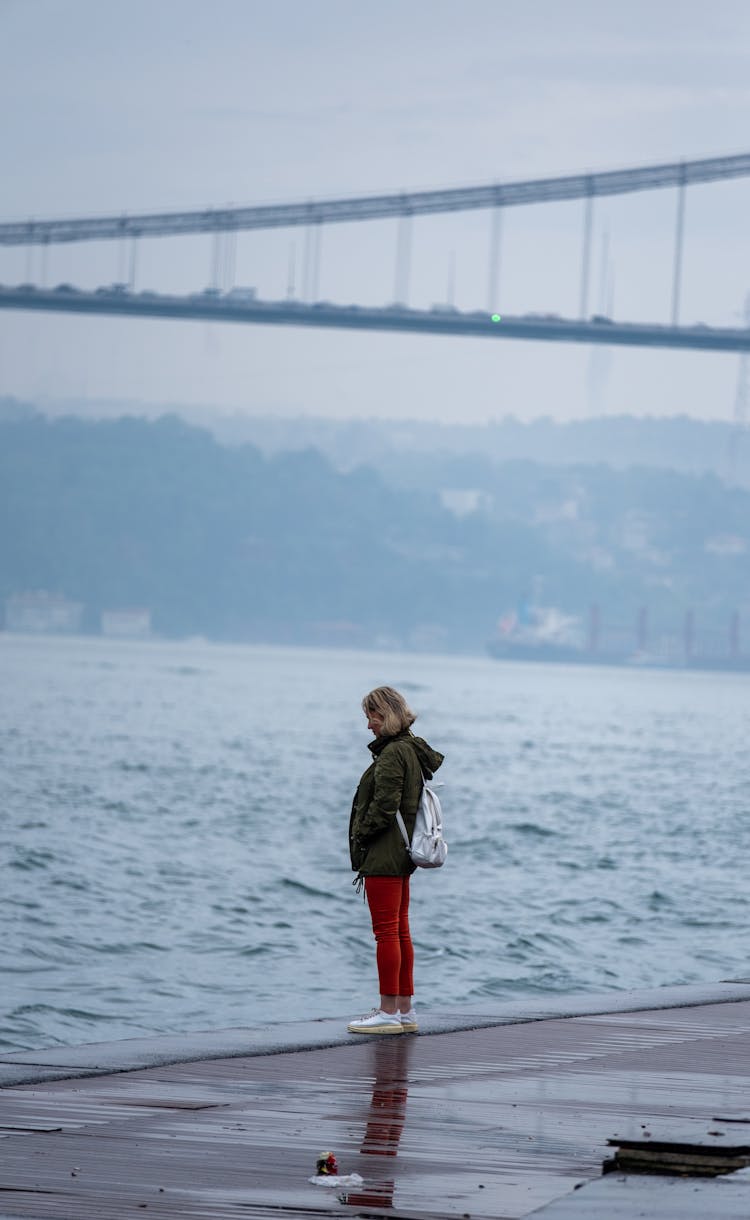 Candid Picture Of A Woman Standing On The Beach Alone 