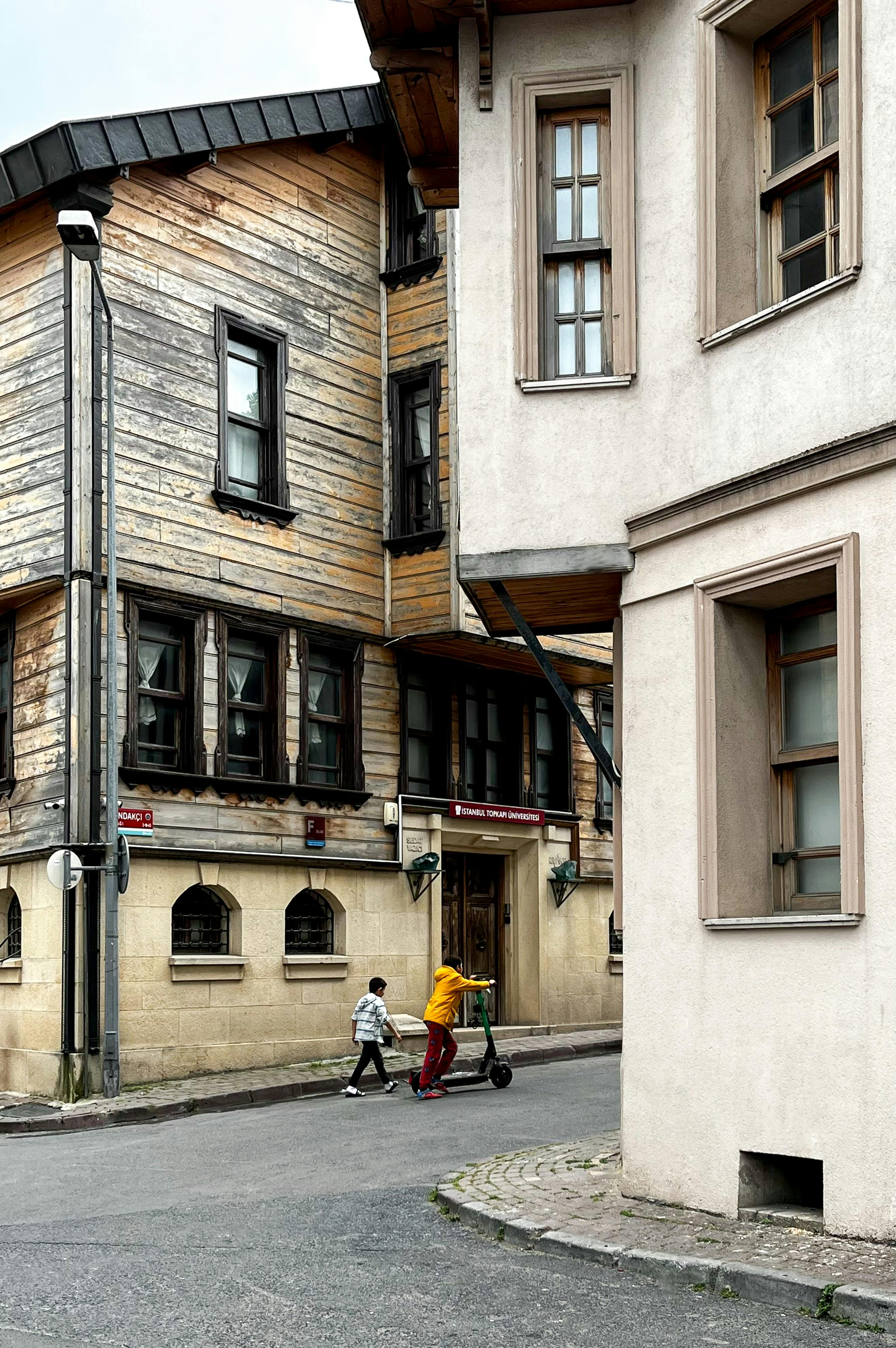 a man riding a bike down a narrow street