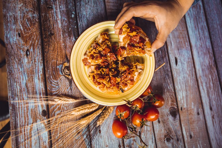 Person Taking A Slice Of A Dish From The Plate 