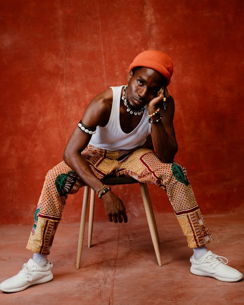 Man in a White Tank Top and Red Cap 