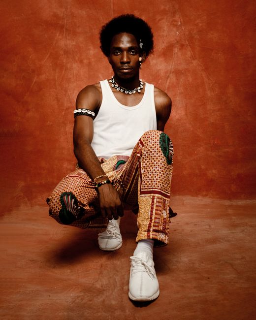 A captivating portrait of a young man in vibrant attire, showcasing modern fashion and style.