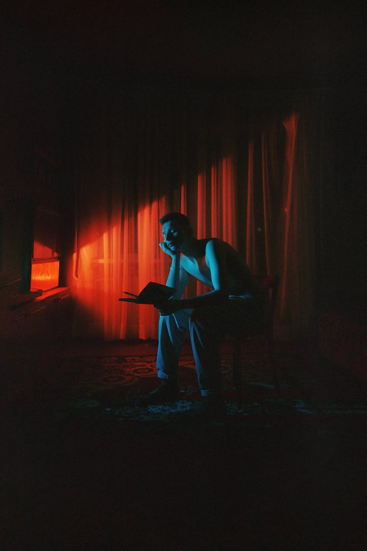 Man With Book In Darkness