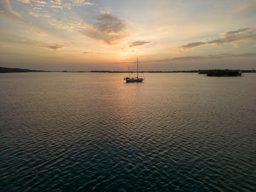 A Sailboat on a Lake at Sunset 