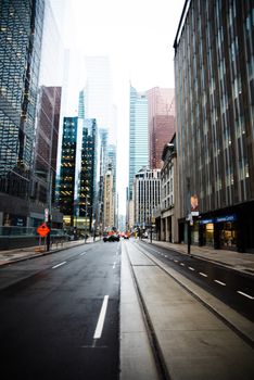 Vibrant street scene in downtown Toronto, showcasing skyscrapers and urban architecture.