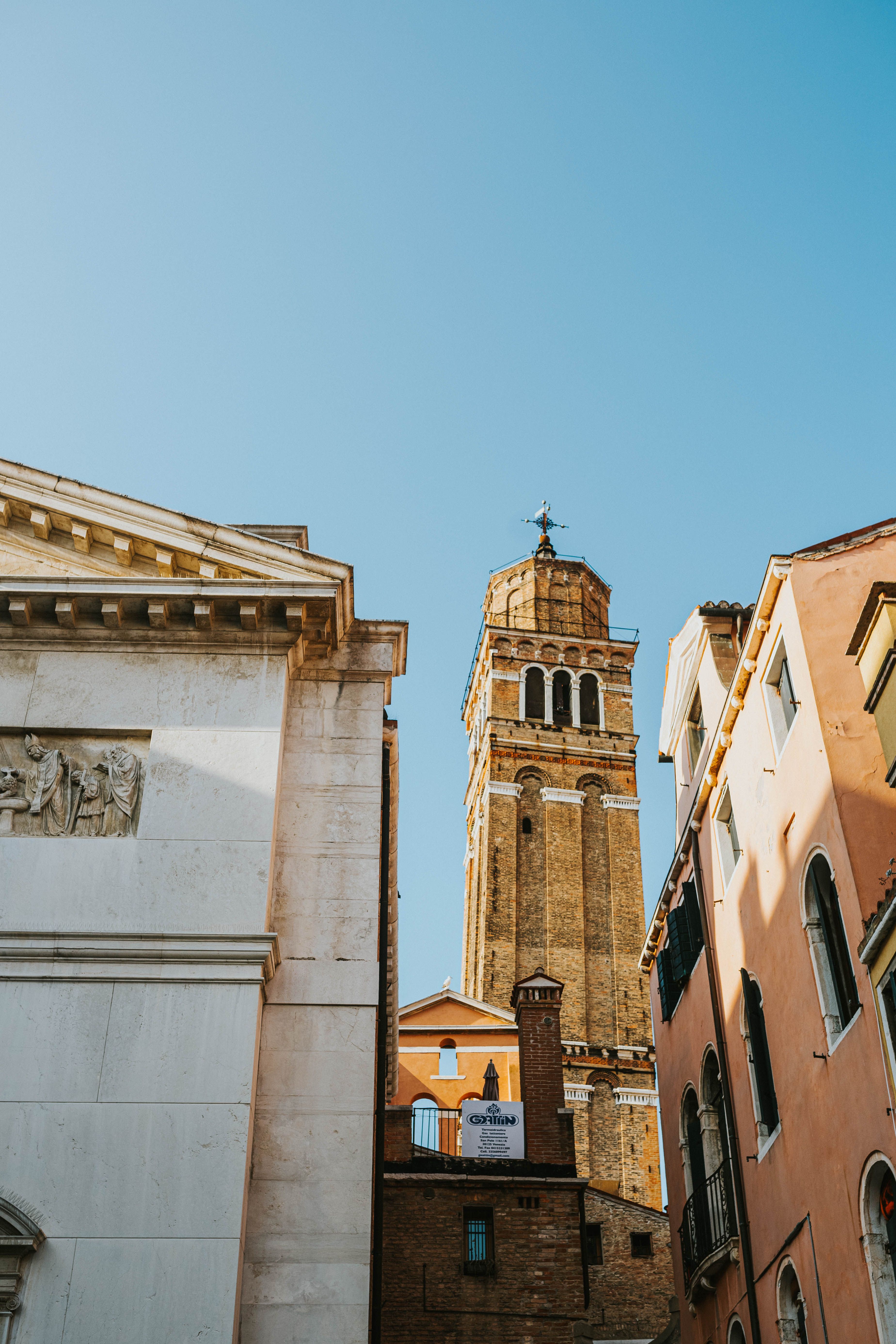 Photograph of San Maurizio Church bell tower with clear sky in Venice, Italy.