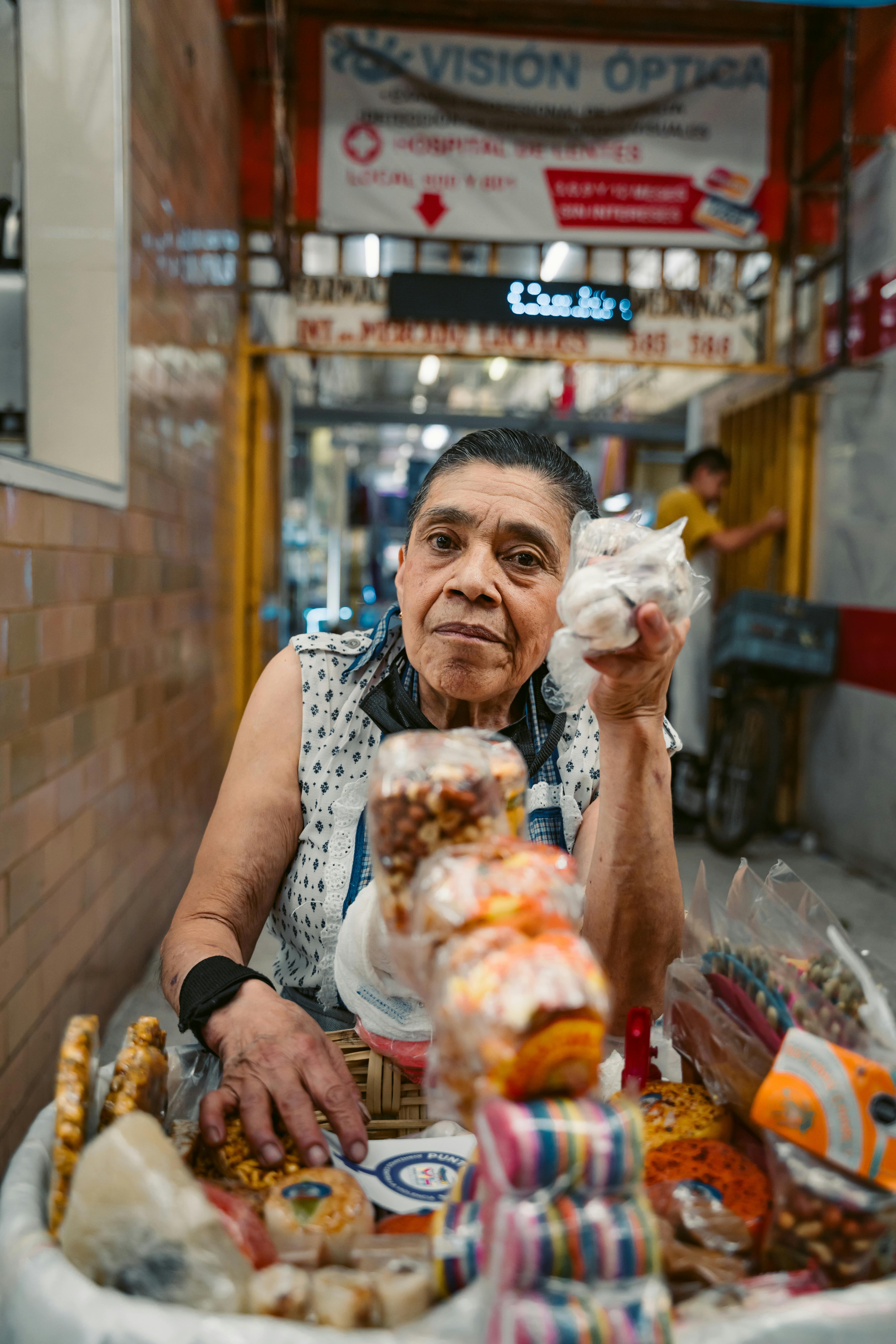An elderly vendor selling snacks in a narrow alley in Mexico City. Vibrant urban scene.