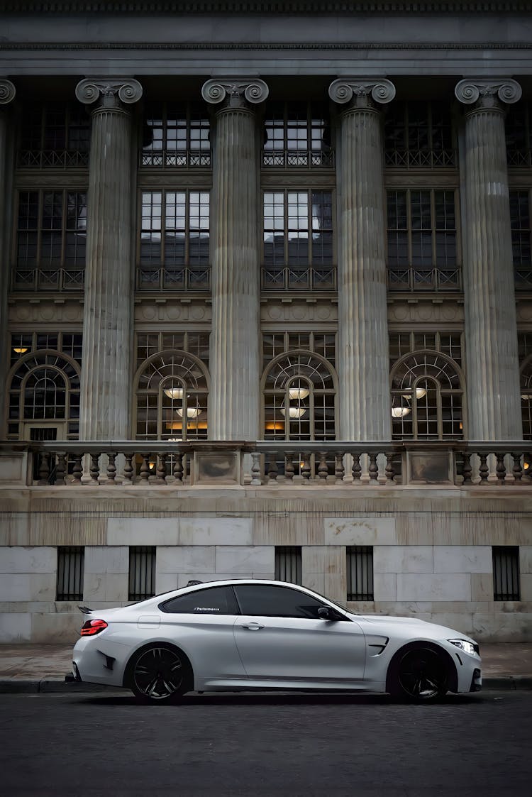 Car Against Neoclassical Facade With Ionic Columns