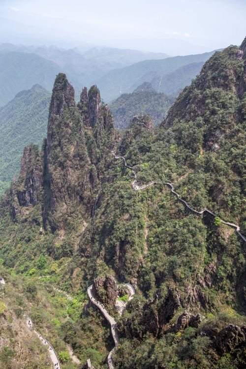 Free A breathtaking aerial view of mountains with pathways winding through lush greenery. Stock Photo