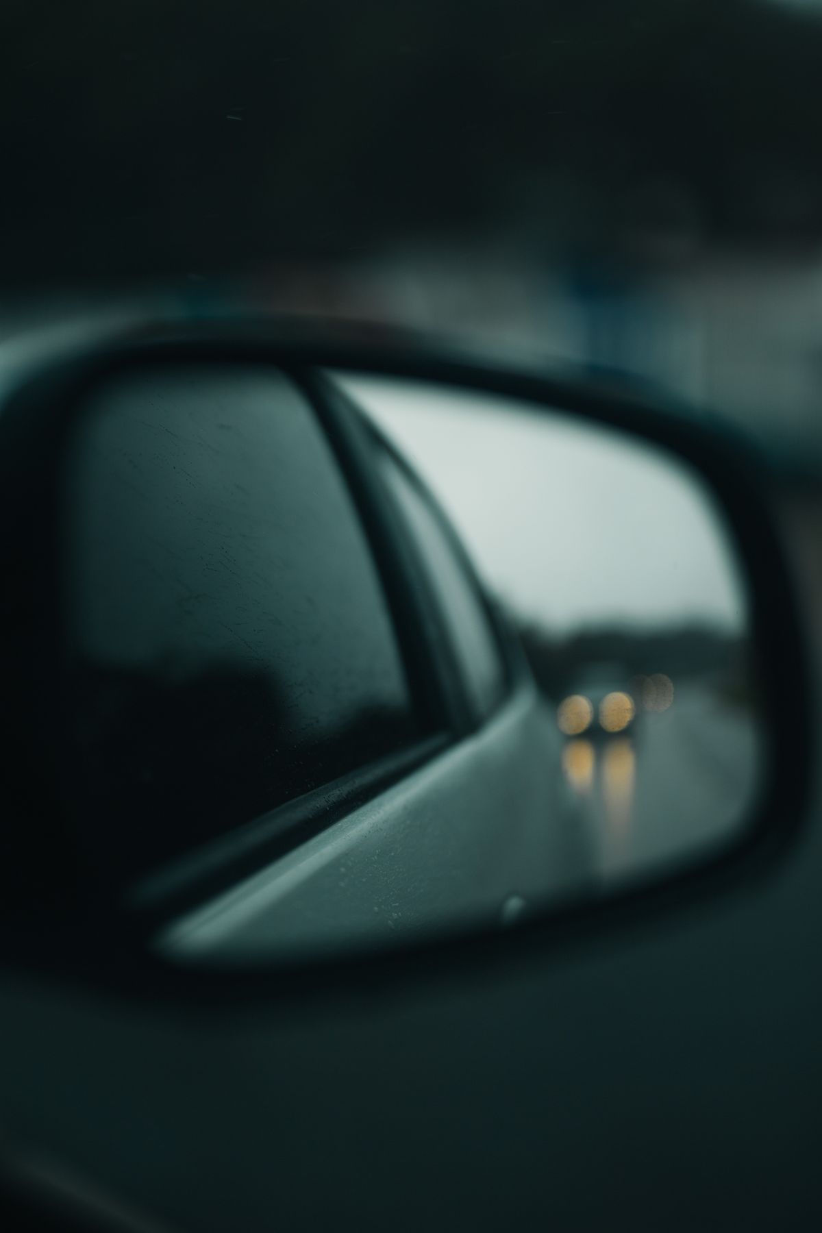 Close-up of a car side mirror, symbolizing the financial blind spots we can't see from the driver's seat