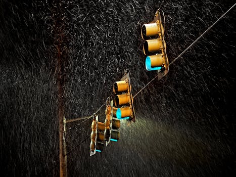 Traffic lights glowing in the rain with a long exposure effect at night.