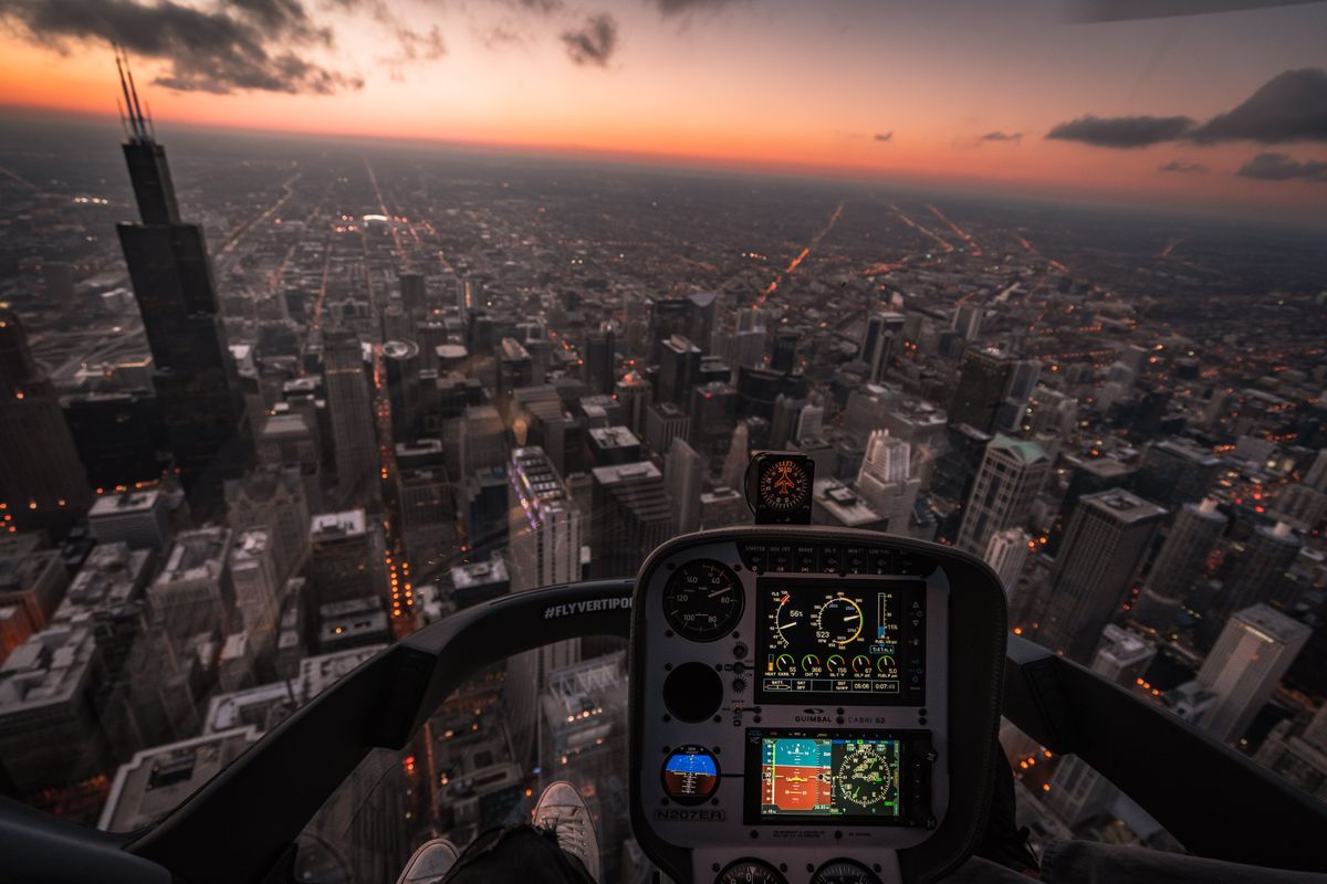 eVTOL air taxi aircraft flying above city buildings representing advanced air mobility