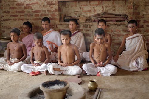 Group of Boys Sitting Together during a Traditional Ceremony 