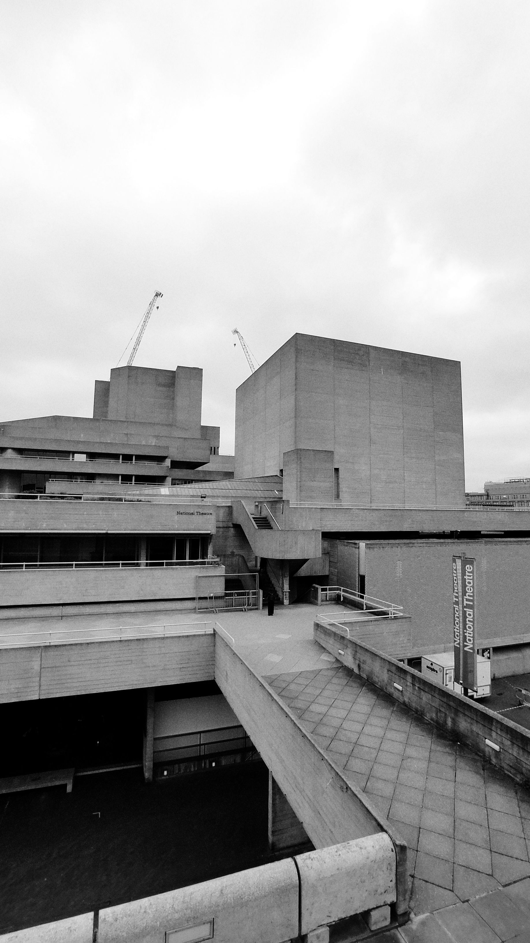 Black and white photo of modern brutalist architecture featuring concrete structures.. black, white, photo