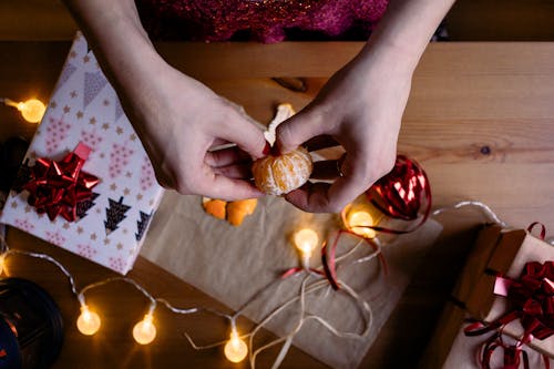 Free Person Holding a Orange Fruit Stock Photo