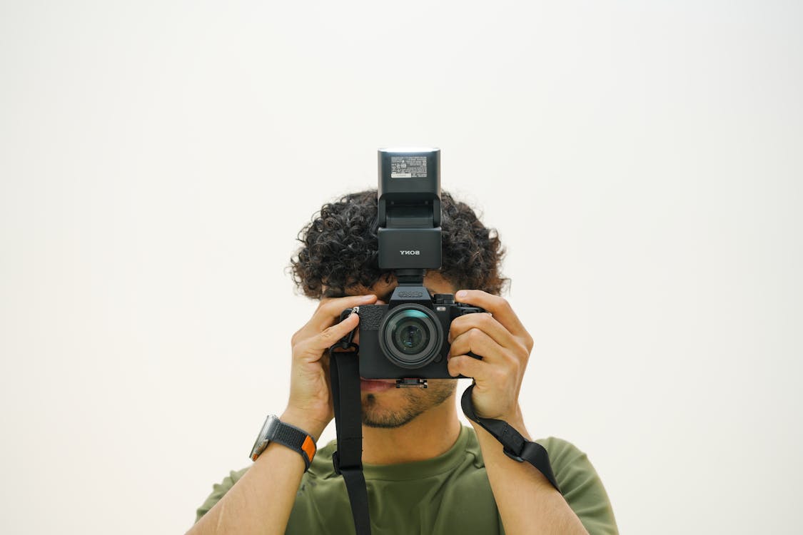 Man Using a Camera against a White Background