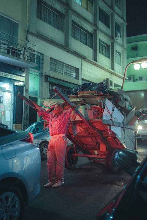 Man Holding Carriage at Night