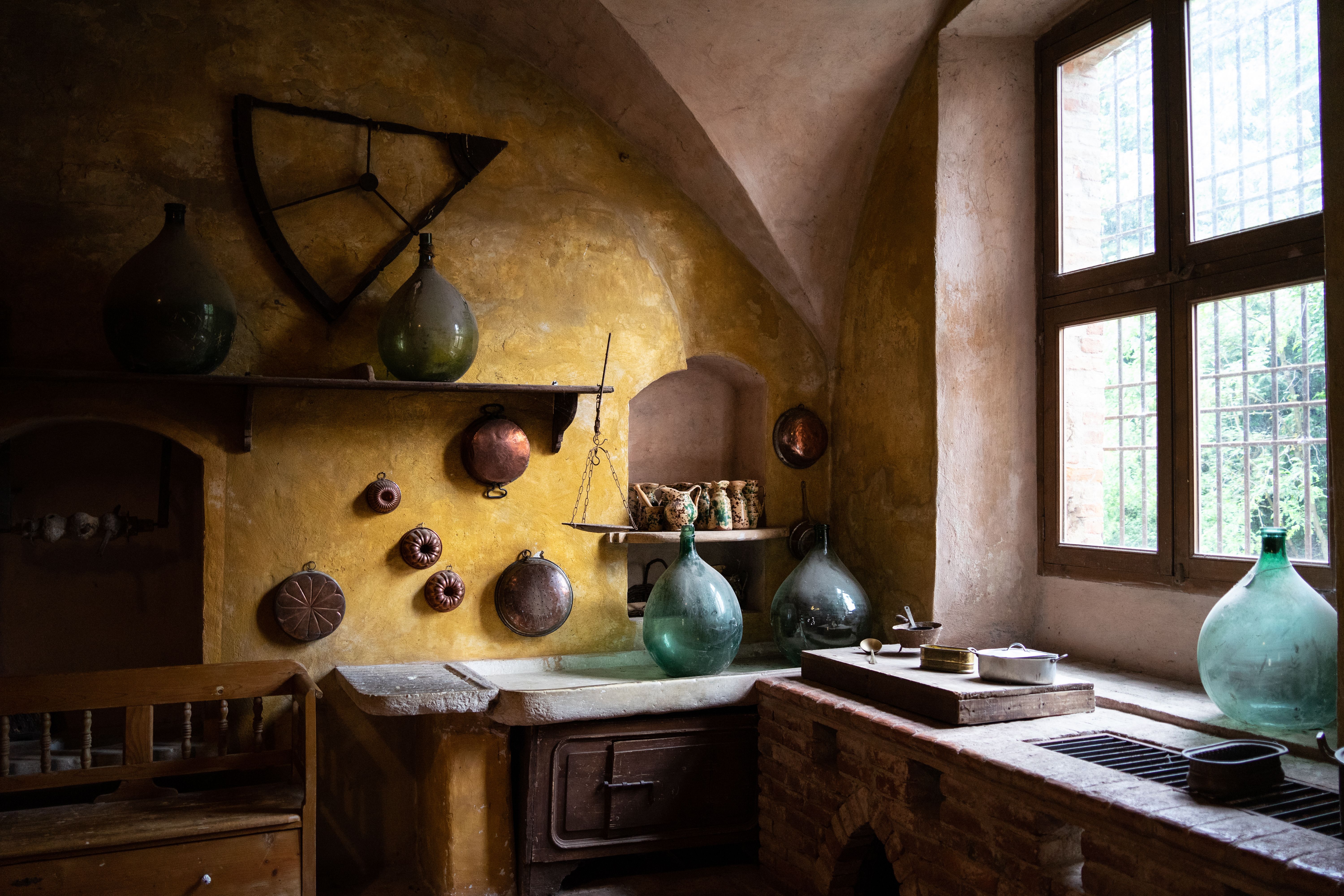 Vintage kitchen in Padernello, Italy with rustic decor and vintage glass vases.