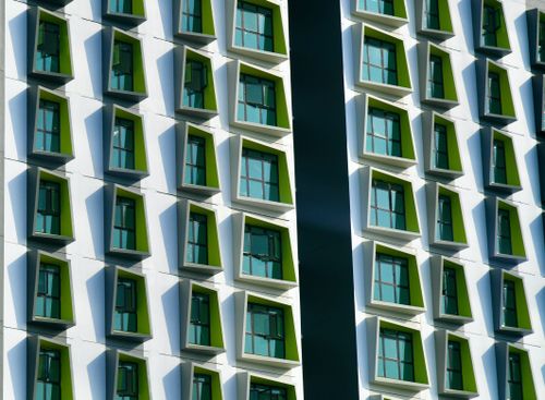 Free Dynamic angled window design on a modern building in Singapore. Stock Photo