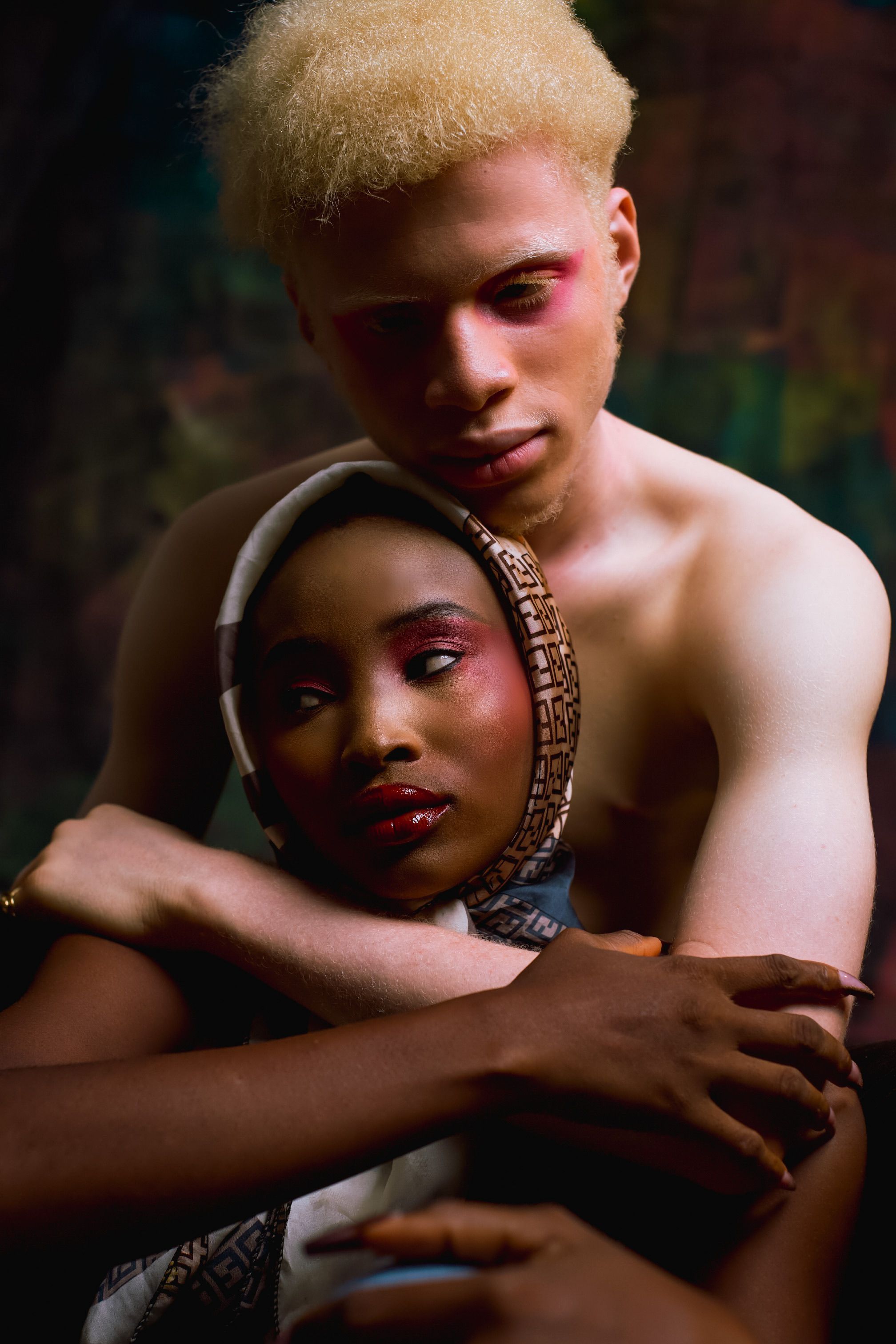 A fashion-forward portrait of a couple embracing, showcasing style and diversity.
