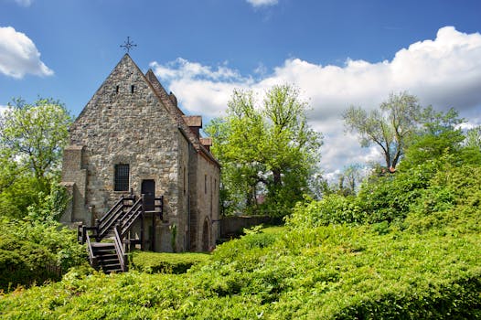Chapel Saint Calixte in Mons, Belgium amidst vibrant greenery on a sunny day.
