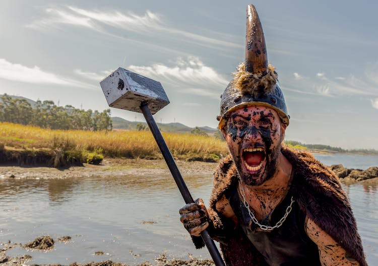 Man In Viking Costume Holding Hammer Screaming