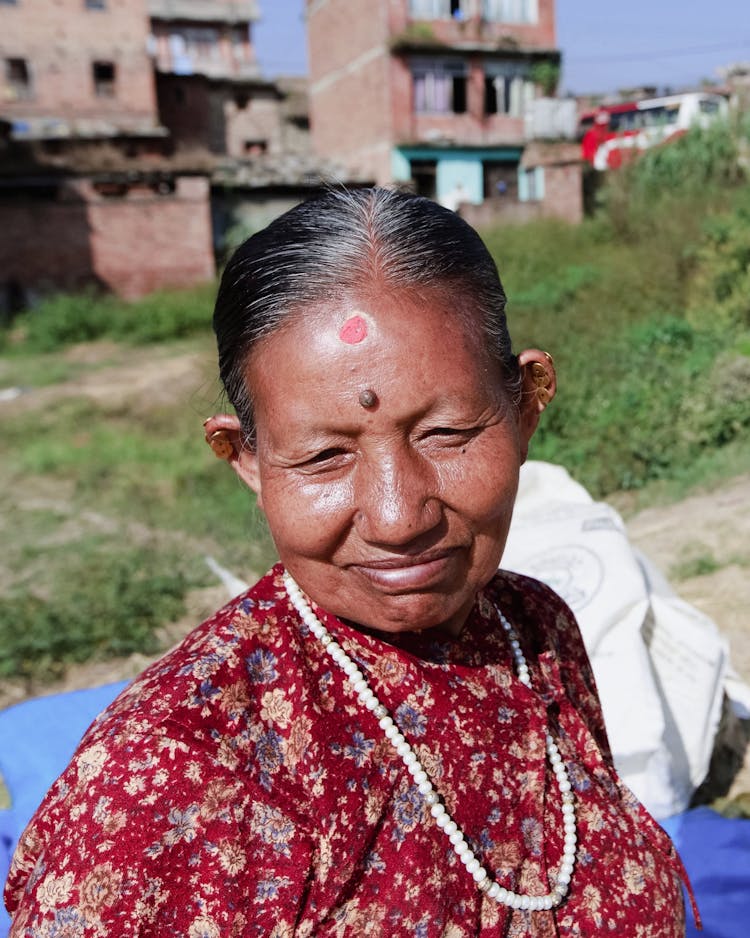 Portrait Of Smiling Old Woman With Birthmark On Head