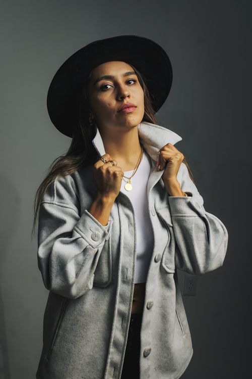Free Portrait of a fashionable woman in a hat and jacket, exuding confidence and style. Stock Photo