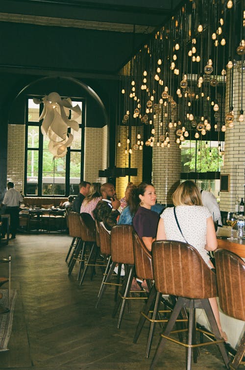 People Sitting on Chairs in a Restaurant