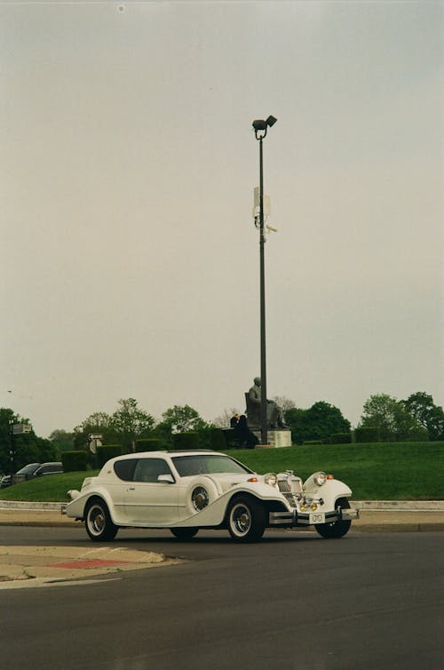 A Vintage Car on a Road 