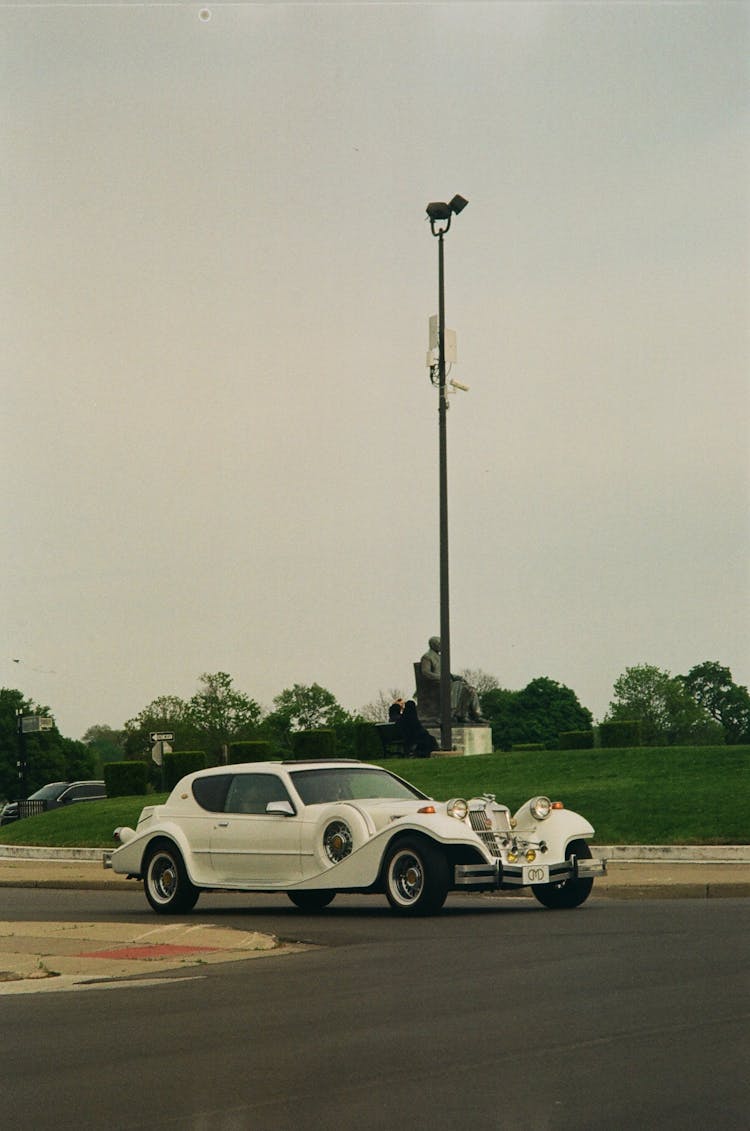 A Vintage Car On A Road 