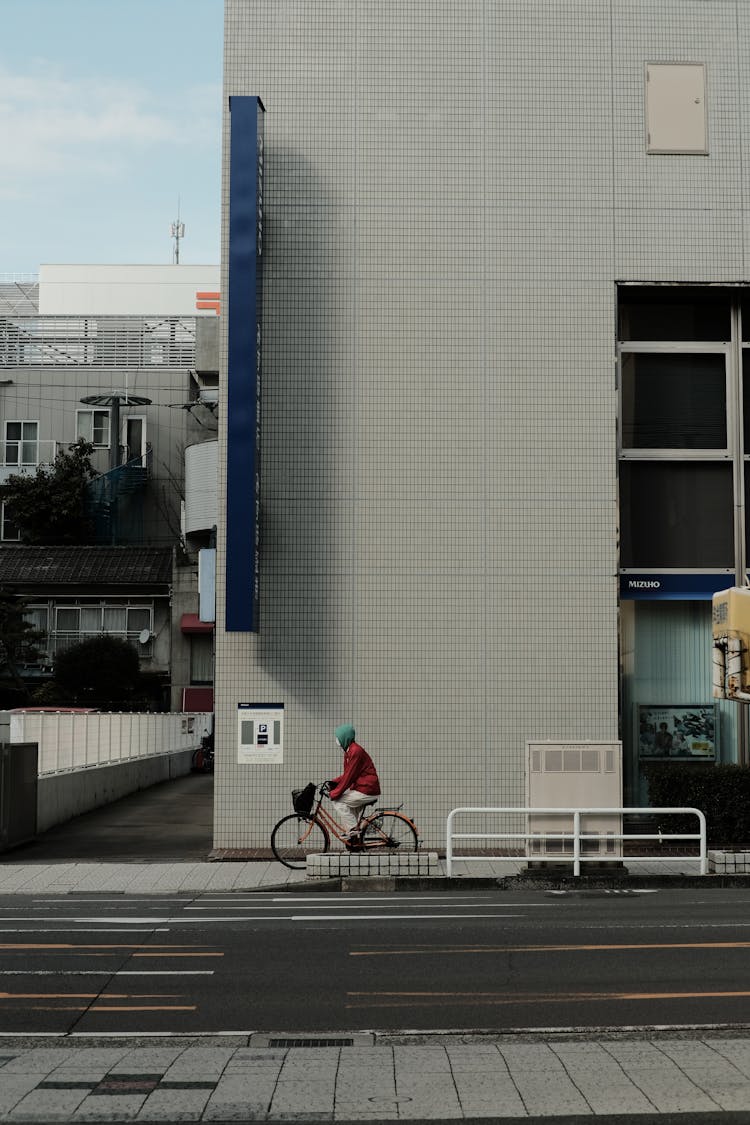 Man Riding On Bicycle In City