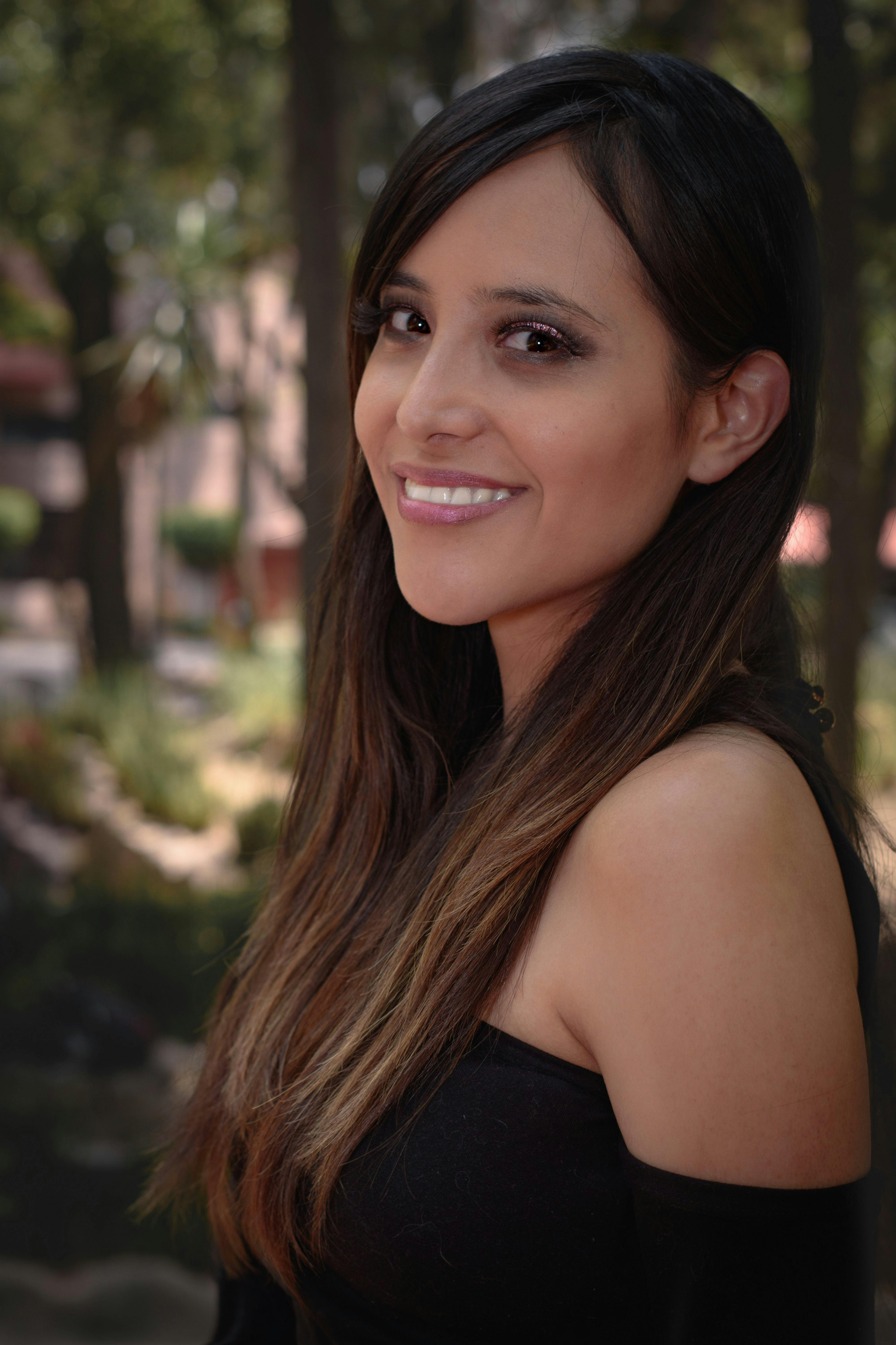 Portrait of a smiling woman in a summer forest in Mexico.