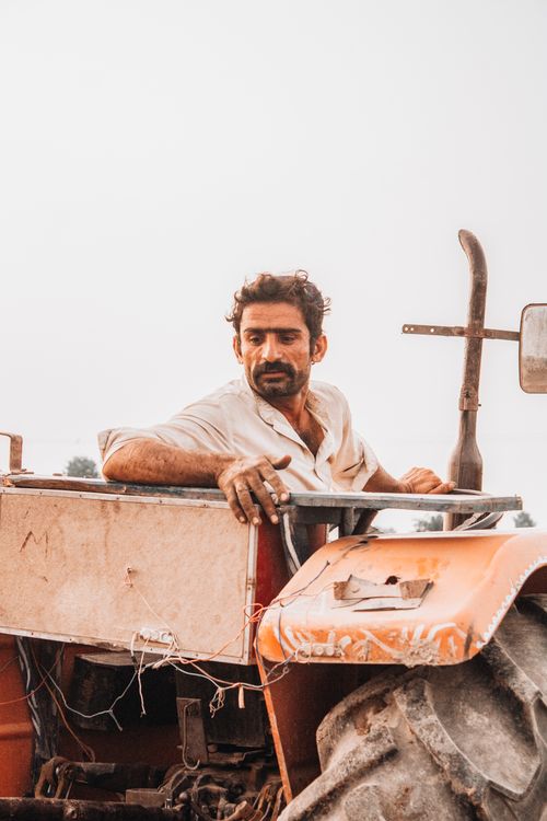 Free A farmer operating a tractor in Sadiqabad, Pakistan, showcasing agricultural life. Stock Photo