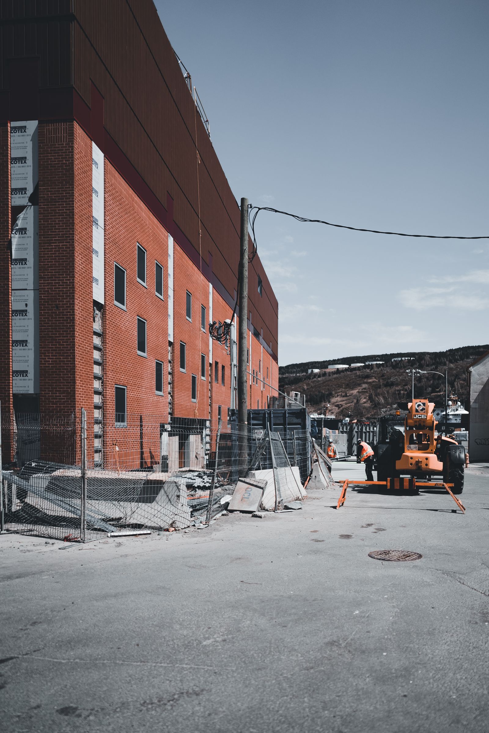 Construction site with heavy equipment and safety fencing