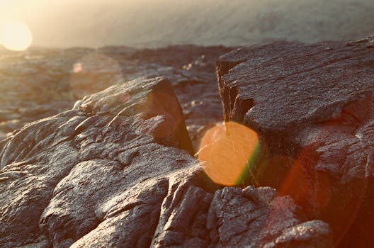 特写镜头捕捉了岩石地形，阳光与散景营造出戏剧性效果