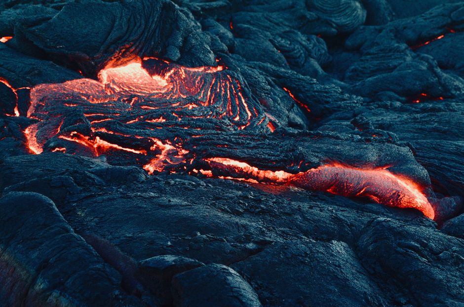 Big Island, Hawaii: Volcanoes National Park Safari - A mesmerizing view of flowing lava on a volcanic landscape, capturing the intense heat and texture.