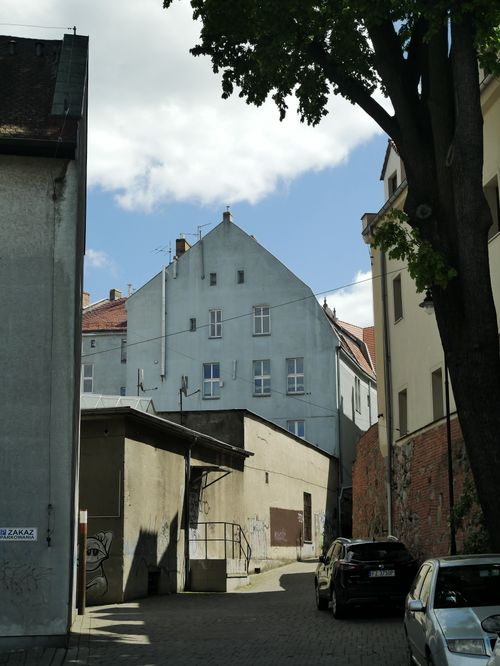 Free Explore the quaint alleys of Zielona Góra with classic European architecture under a sunny sky. Stock Photo