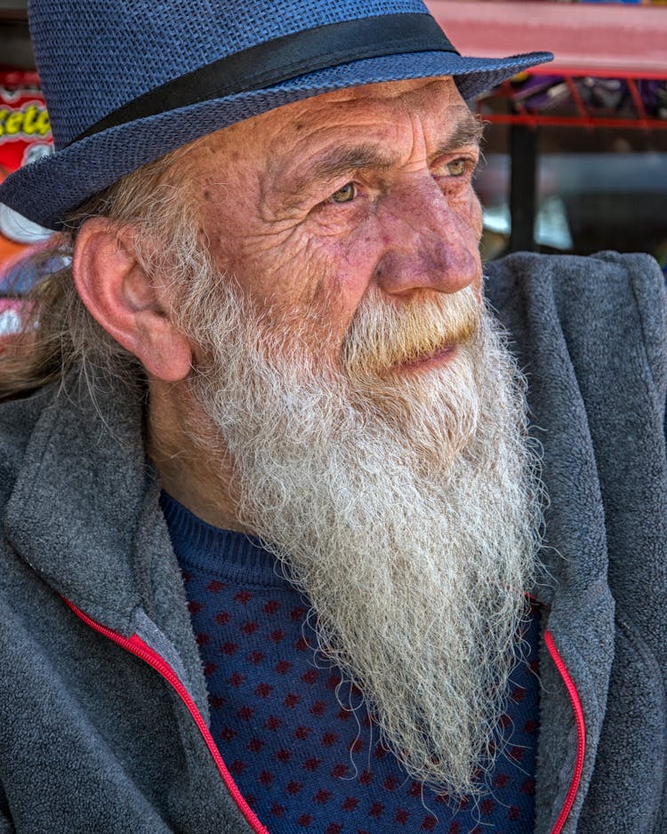 Portrait Of An Elderly Man In Blue Hat With Long Gray Beard