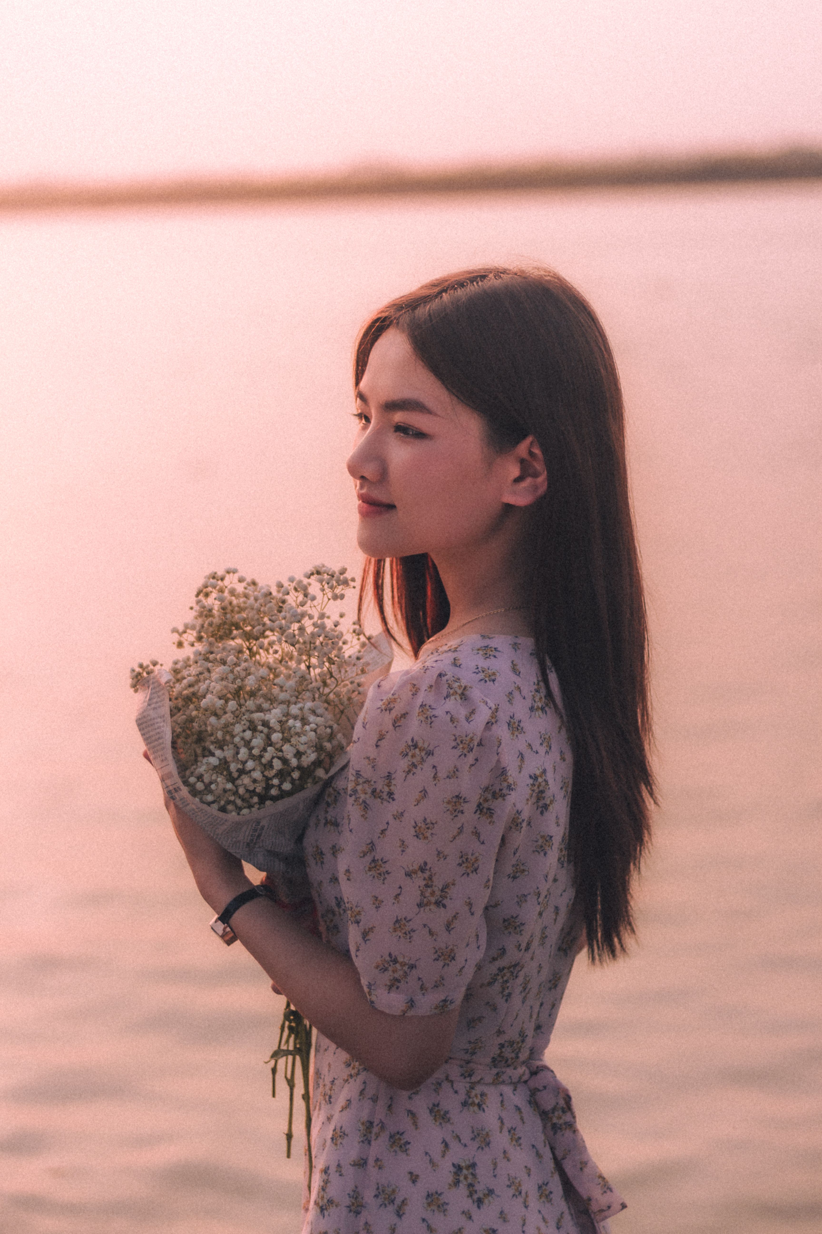 Woman Posing with Flowers Bouquet near Water · Free Stock Photo