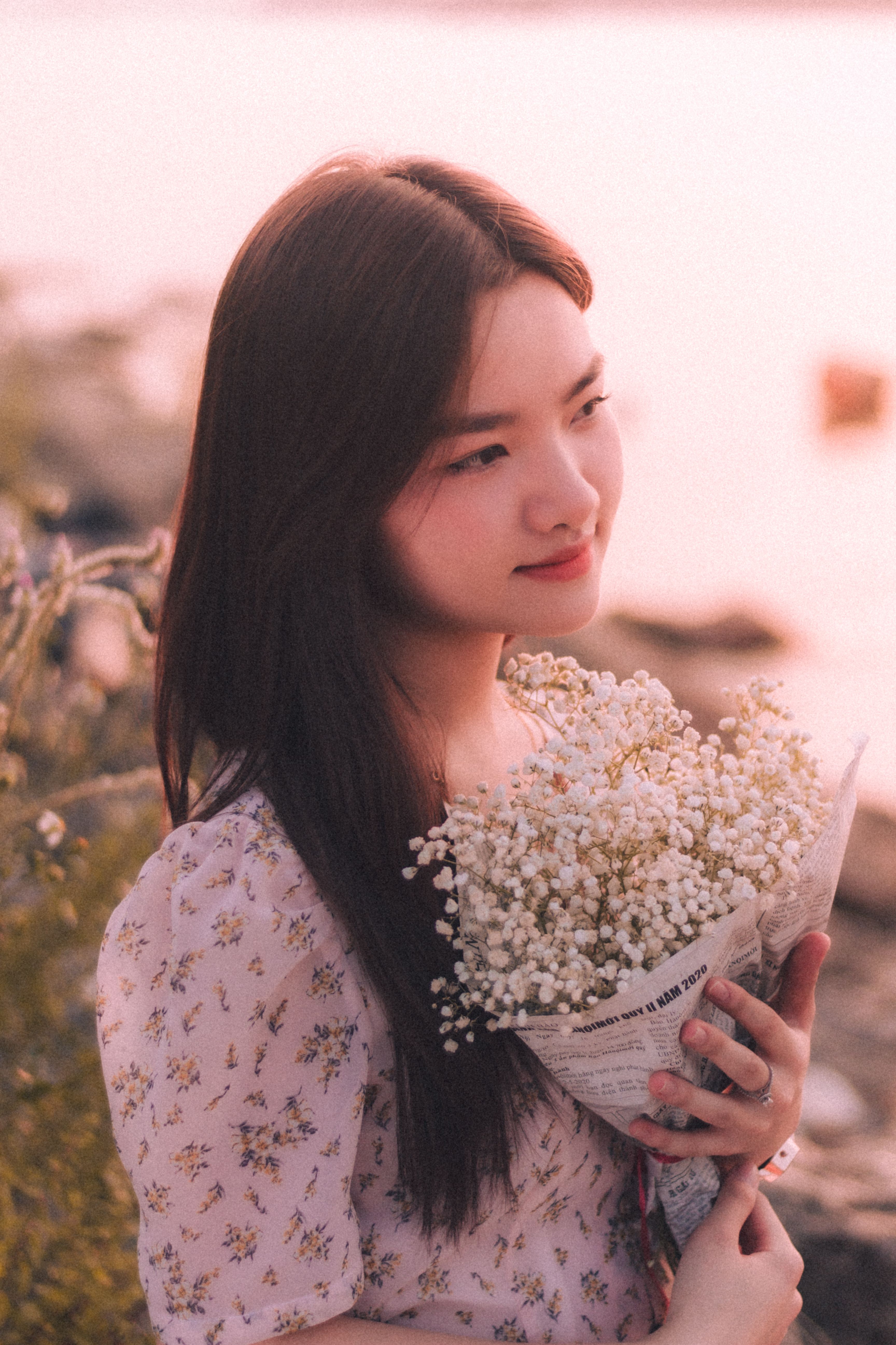 Young Woman Holding a Bunch of Flowers · Free Stock Photo