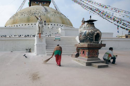A Person Sweeping the Floor in Front of Boudhanath Stupa, Kathmandu, Nepal